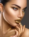 Fashion art makeup. Portrait of beauty woman with golden skin. Shiny professional makeup Royalty Free Stock Photo