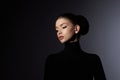 Fashion art studio portrait of beautiful elegant woman in black turtleneck. Hair high beam, perfect profile face. Elegant beauty Royalty Free Stock Photo