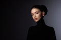 Fashion art studio portrait of beautiful elegant woman in black turtleneck. Hair high beam, perfect profile face. Elegant beauty Royalty Free Stock Photo