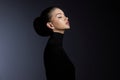 Fashion art studio portrait of beautiful elegant woman in black turtleneck. Hair high beam, perfect profile face. Elegant beauty Royalty Free Stock Photo