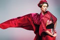 Fashion asian woman wearing traditional japanese red kimono. Geisha Royalty Free Stock Photo