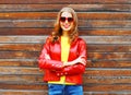 Fashion autumn smiling woman wearing a red leather jacket