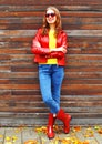 Fashion autumn smiling woman wearing a red leather jacket