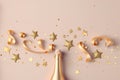 Fashion background with golden champagne bottle, confetti stars, holiday decoration and party streamers in flat lay style. Royalty Free Stock Photo