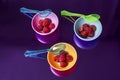 Fashion background with raspberries on multicolored containers