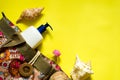 Fashion beach accessories - bag, suntan lotion, seashells and sunscreen on a yellow background Royalty Free Stock Photo