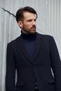 Fashion beard style business handsome male model posing in style clothing blue jacket on street wall outdoors background. Closeup Royalty Free Stock Photo