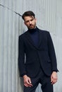 Fashion beard style business handsome male model posing in style clothing blue jacket and trousers on street wall outdoors Royalty Free Stock Photo