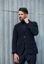 Fashion beard style business handsome male model with serious concentrated look posing in style clothing wall outdoors background Royalty Free Stock Photo