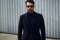 Fashion beard style business handsome man posing in style clothing and trendy sun glasses on street wall outdoors background. Royalty Free Stock Photo