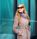 Fashion beautiful blonde woman wearing coat jacket and sunglasses in city Royalty Free Stock Photo