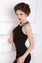 Fashion beautiful brunette girl model in black dress posing Royalty Free Stock Photo