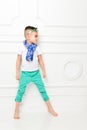 Fashion beautiful little boy in bright pants and t-shirt and scarf