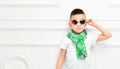 Fashion beautiful little boy in bright pants and t-shirt and scarf