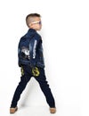 Fashion beautiful little boy standing standing backward rear vie