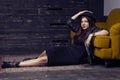 Fashion beautiful middle eastern model with hipster style is posing on carpet and yellow sofa. Royalty Free Stock Photo