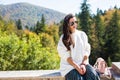 Fashion beautiful woman portrait wearing sunglasses, white sweater and green skirt