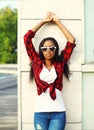 Fashion beautiful young african woman wearing a red checkered shirt and sunglasses in the city Royalty Free Stock Photo