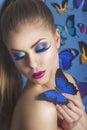 Fashion Beauty Gir with a butterfly on her handl. Gorgeous Woman Portrait. Hairstyle. Make up. Vogue Style. Glamour Girl. Royalty Free Stock Photo