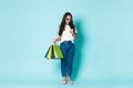 Fashion, beauty and lifestyle concept. Full-length shot of stylish attractive asian woman holding shopping bags and Royalty Free Stock Photo