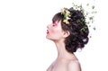 Fashion beauty model girl with a chaplet from flowers in hair. Creative makeup and hairstyle. Royalty Free Stock Photo