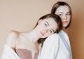 Fashion beauty models two sisters twins beautiful nude girls looking at the camera on beige background Royalty Free Stock Photo