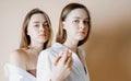 Fashion beauty models two sisters twins beautiful nude girls looking at the camera isolated on beige background Royalty Free Stock Photo