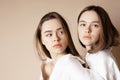 Fashion beauty models two sisters twins beautiful nude girls looking at the camera isolated on beige background Royalty Free Stock Photo