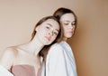 Fashion beauty models two sisters twins beautiful nude girls looking at the camera isolated on beige background Royalty Free Stock Photo