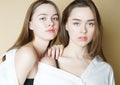 Fashion beauty models two sisters twins beautiful nude girls looking at the camera isolated on beige background Royalty Free Stock Photo