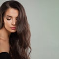 Fashion beauty portrait of young perfect female model brunette with long curly hairstyle. Beautiful woman face close up Royalty Free Stock Photo