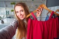 Fashion blogger woman in jeans and turtleneck showing casual colorful shirts on camera. Stylist influencer girl showing