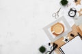 Fashion blogger workspace background. Coffee, office supply, alarm and clean notebook on white desk top view. Flat lay style. Royalty Free Stock Photo