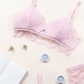 Woman elegant pink lace bra and panties, pumps and jewelry. Stylish lingerie flat lay.