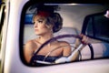 Fashion blond model in retro style in old car Royalty Free Stock Photo