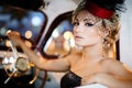 Fashion blond model in retro style in old car Royalty Free Stock Photo