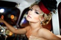 Fashion blond model in retro style in old car Royalty Free Stock Photo