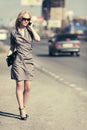 Fashion blond woman calling on cell phone on city street Royalty Free Stock Photo