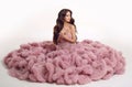 Fashion brunette pretty woman in gorgeous long pink dress posing Royalty Free Stock Photo