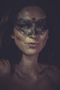 Fashion brunette woman in black mask metal frills