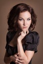 Fashion brunette woman with brown curly hair girl with perfect skin and makeup. Beauty Model retro Royalty Free Stock Photo