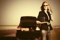 Fashion business woman calling on cell phone next to broken car Royalty Free Stock Photo
