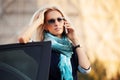 Fashion business woman calling on the phone by her car Royalty Free Stock Photo