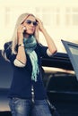 Fashion business woman in sunglasses calling on phone next to car Royalty Free Stock Photo