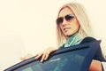 Fashion business woman in sunglasses next to her car