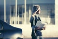 Fashion business woman in sunglasses next to her car