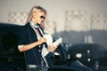 Fashion business woman in sunglasses next to her car