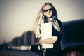 Fashion business woman in sunglasses next to her car outdoor