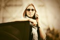 Fashion business woman in sunglasses talking on cell phone next to car Royalty Free Stock Photo