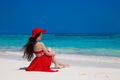 Fashion carefree woman in hat enjoying exotic sea, brunette relax on tropical beach at summer holiday. Attractive girl in red Royalty Free Stock Photo